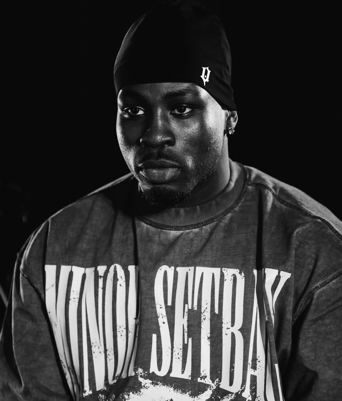 QIH Black Beanie worn with the white Q logo visible
